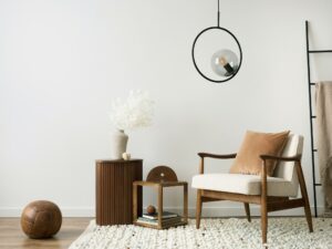 Interior design of aesthetic and minimalist living room with boucle armchair, wooden coffee table