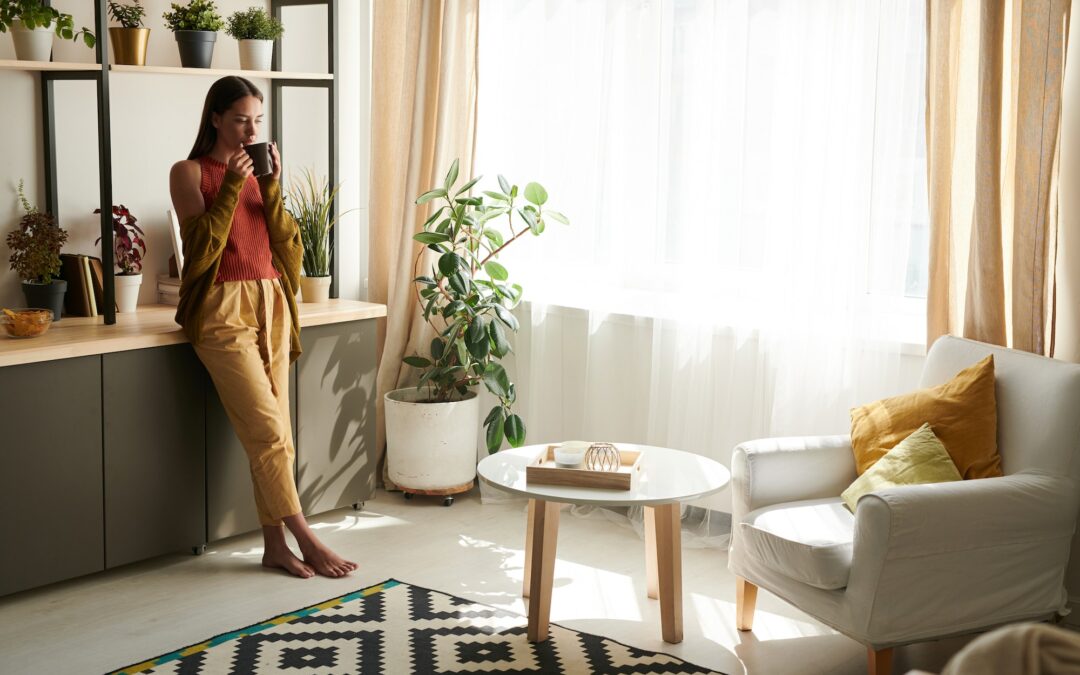 Young woman drinking tea in living room